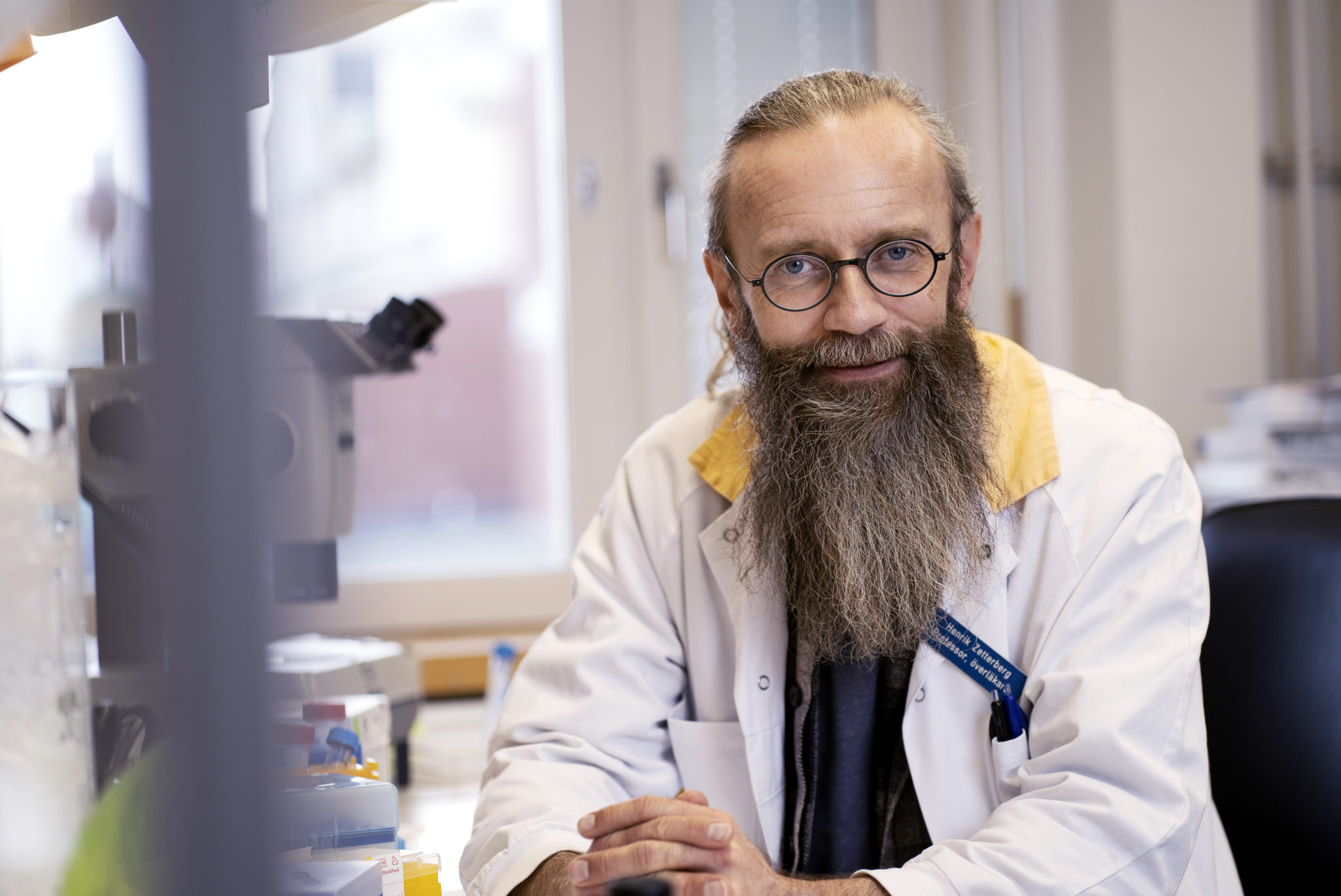 Professor Henrik Zetterberg vid ett mikroskop